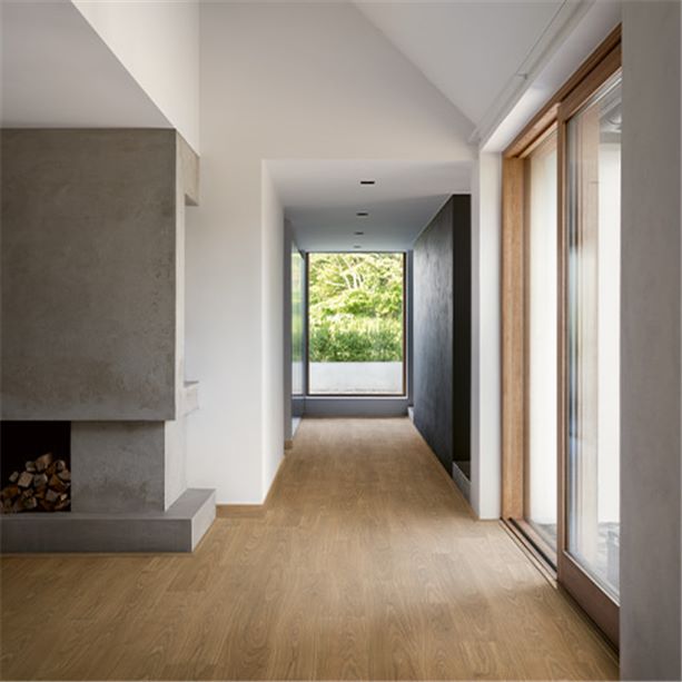 brown laminate floor in a hallway with big windows